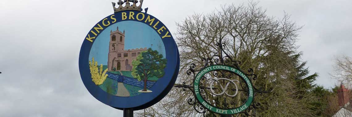 Millennium signpost and Best Kept Village totem pole